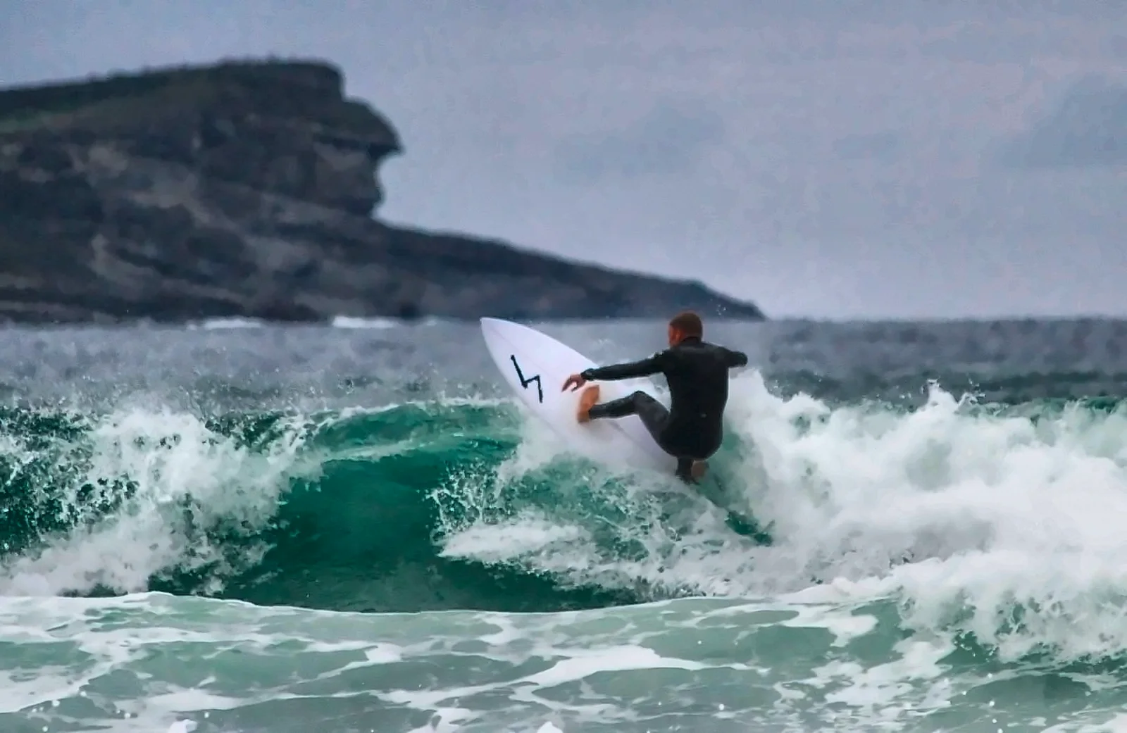 Filippo Lera in onda con la tavola da surf a Somo, in Spagna